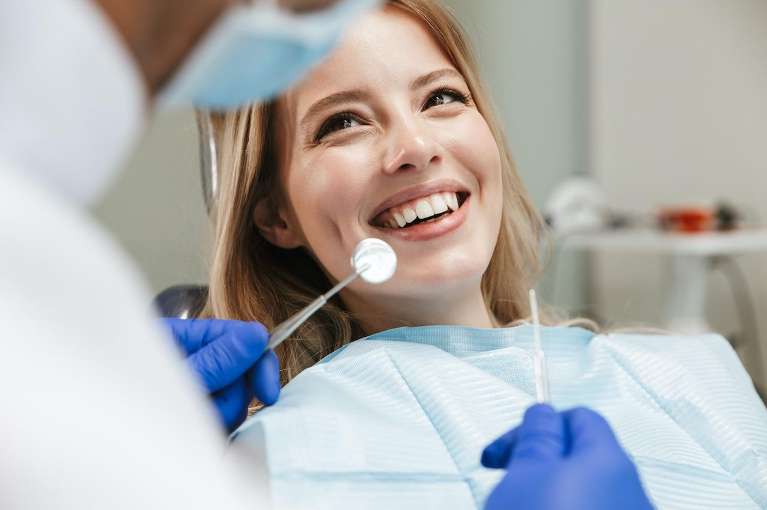woman getting dental cleaning and exam